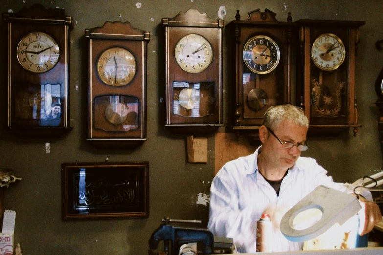 man with a clock in his house