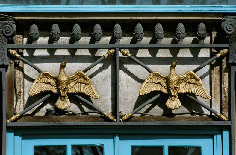 a building with two golden gargonets on the front