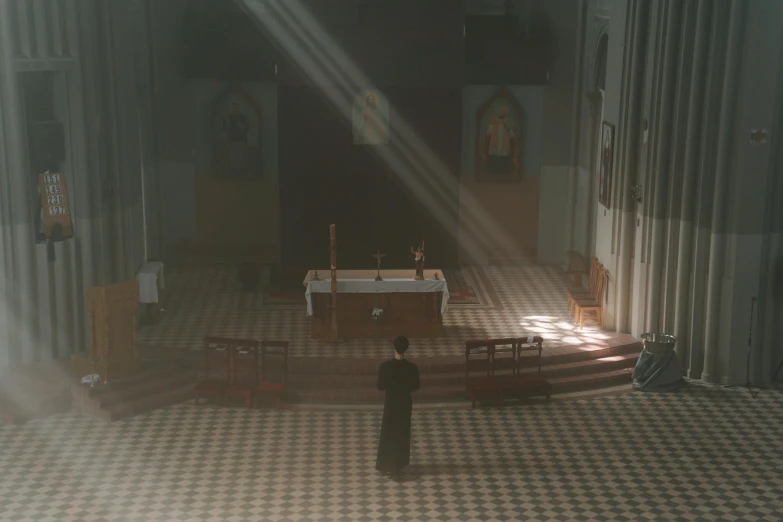 a dark church has an old table and chairs in it