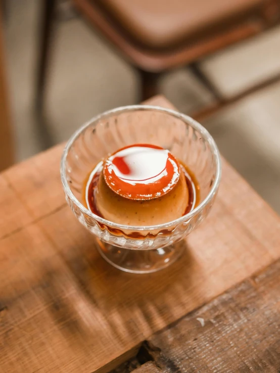 small portion of cake in glass bowl sitting on wooden table