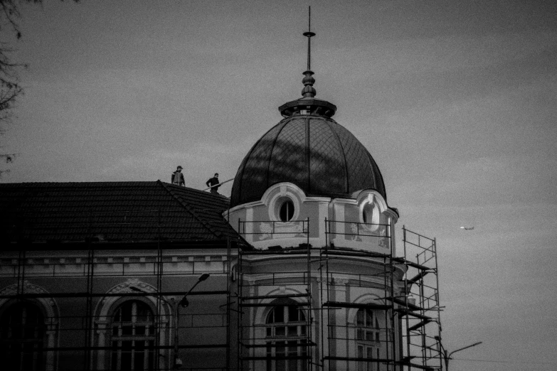 black and white pograph of a building with a scaffolding