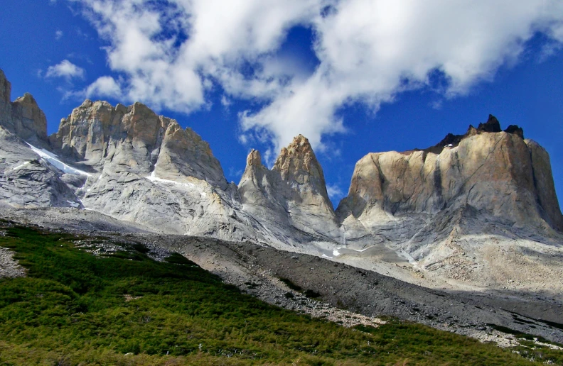 a mountain range with a sky and clouds in the background