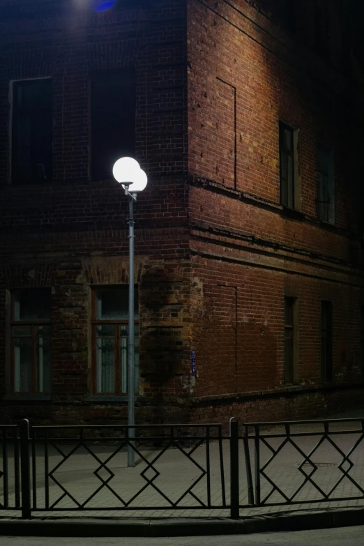 a lamp post on a city street at night