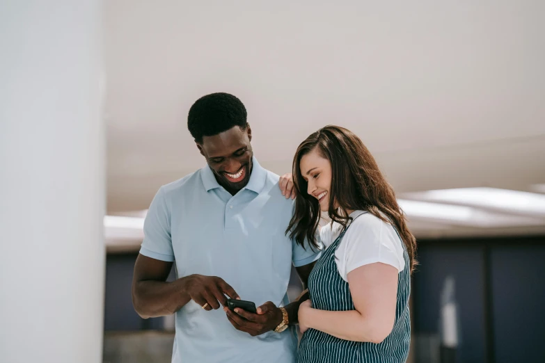 two people that are looking at their phones