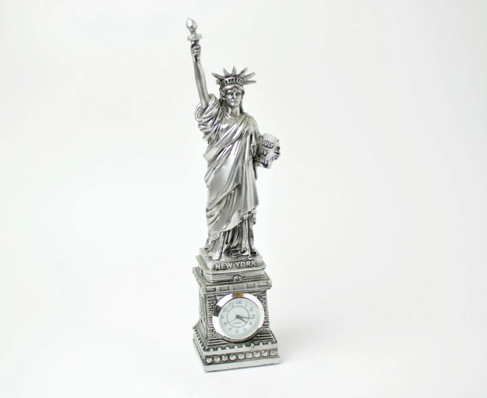 a statue of liberty atop a clock in the white background