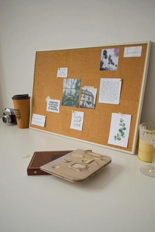 a cork board with pos on it next to a wine glass