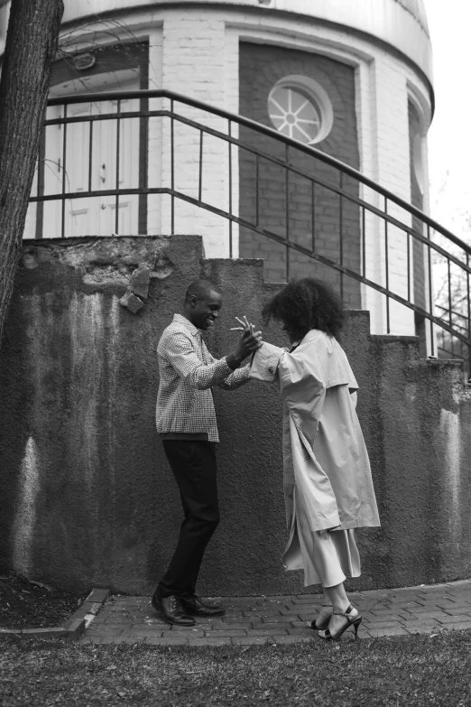 black and white pograph of an african couple on a street corner