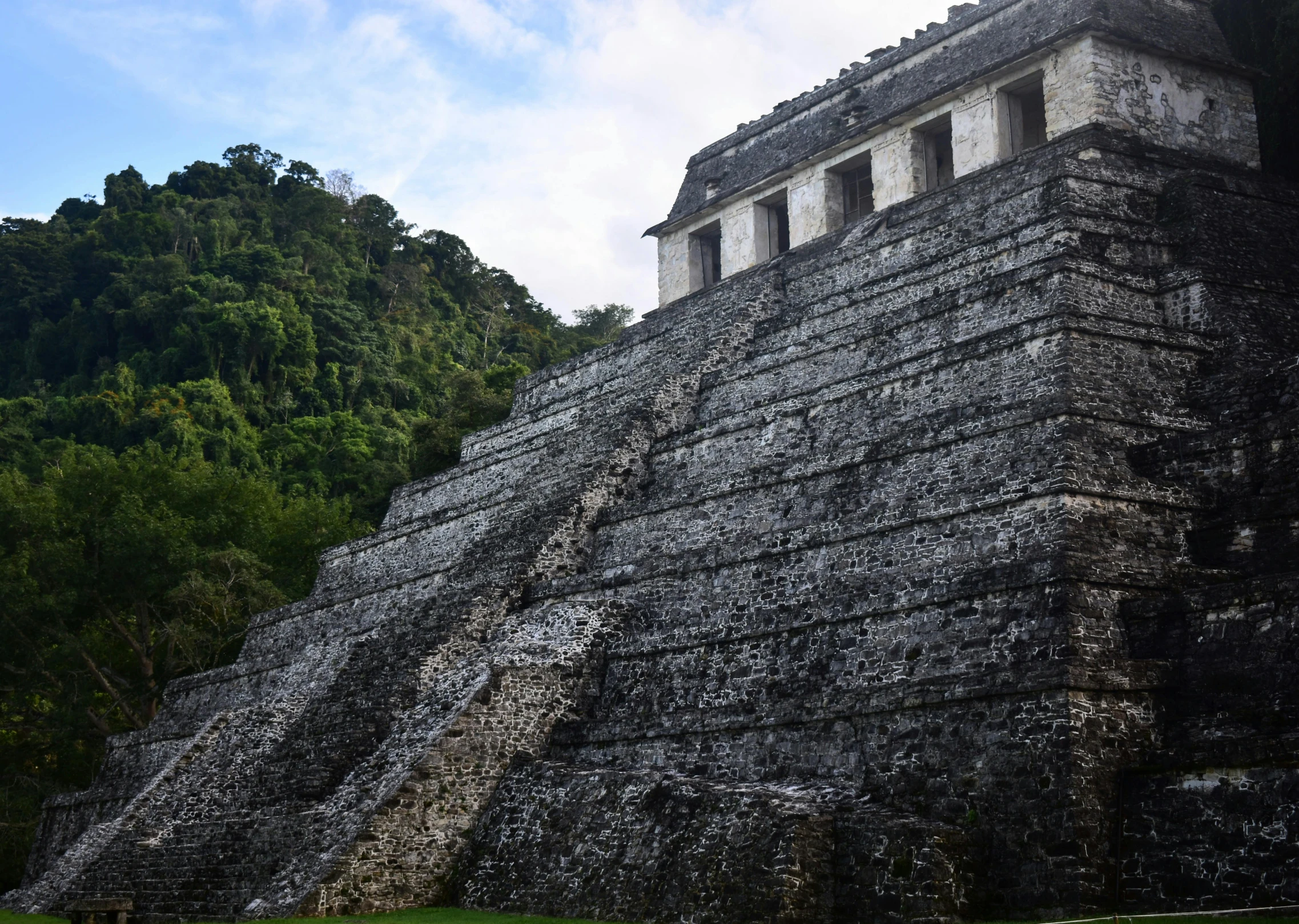 the temple is next to the trees and hill