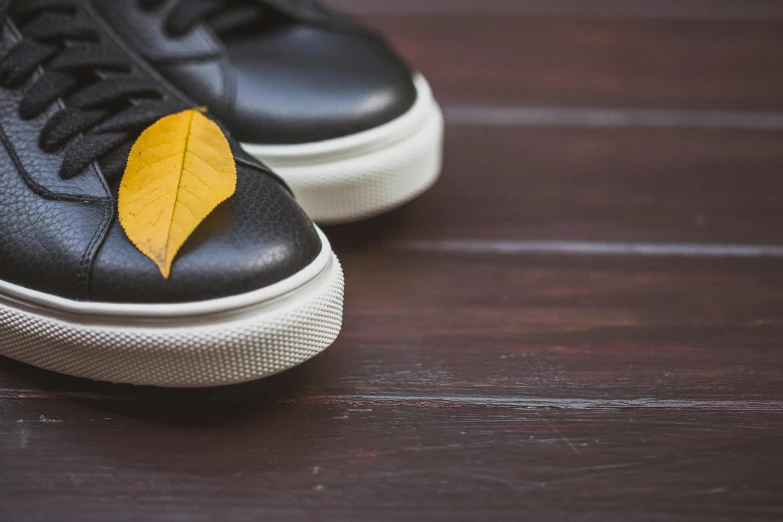 a shoe with a yellow leaf on the top