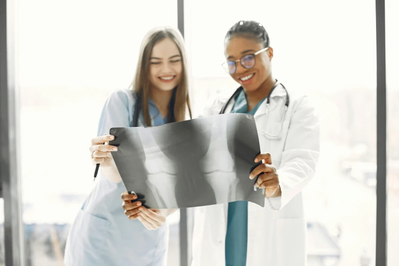 two doctors hold up an x - ray