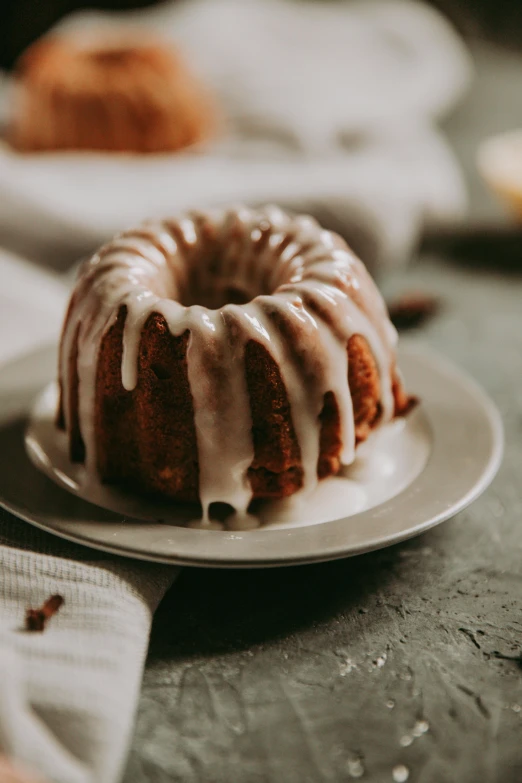 a dessert cake on a white plate next to other cakes