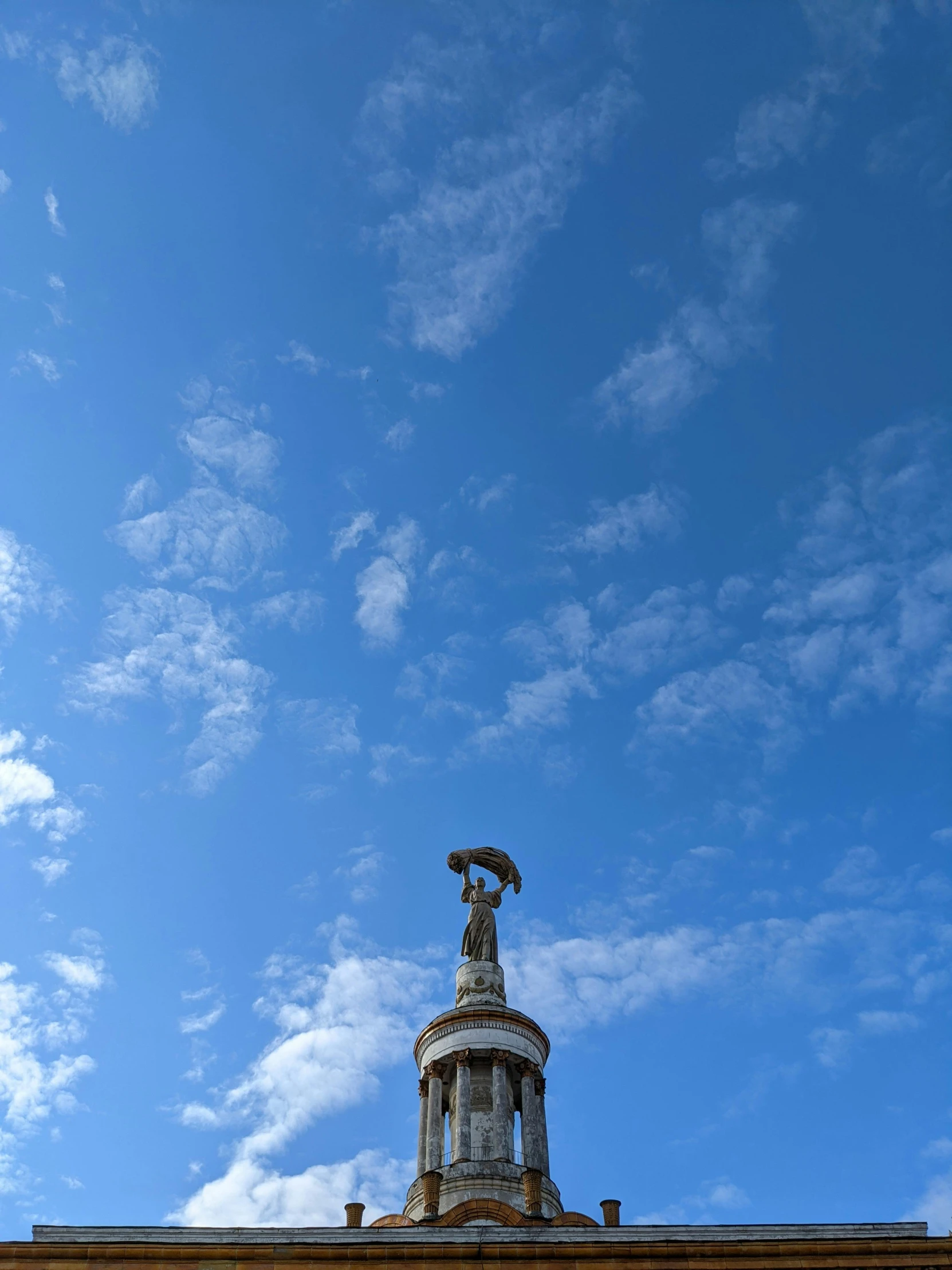 the sky and statue are in contrast, the blue is the only color