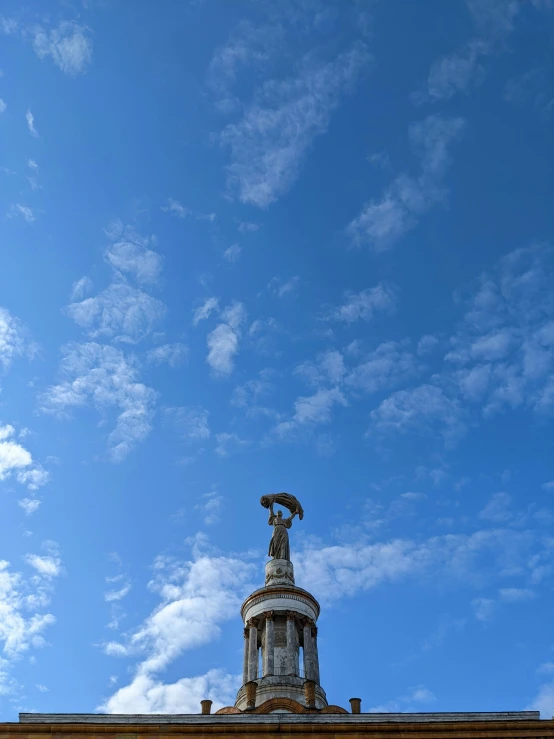 the sky and statue are in contrast, the blue is the only color