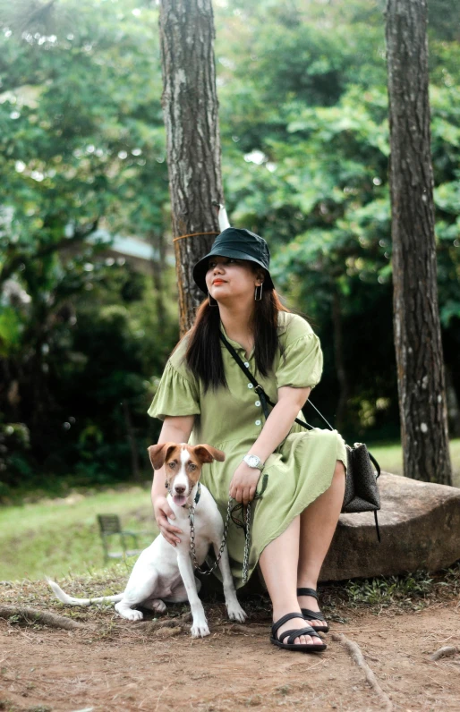 the woman is posing with her dog outside