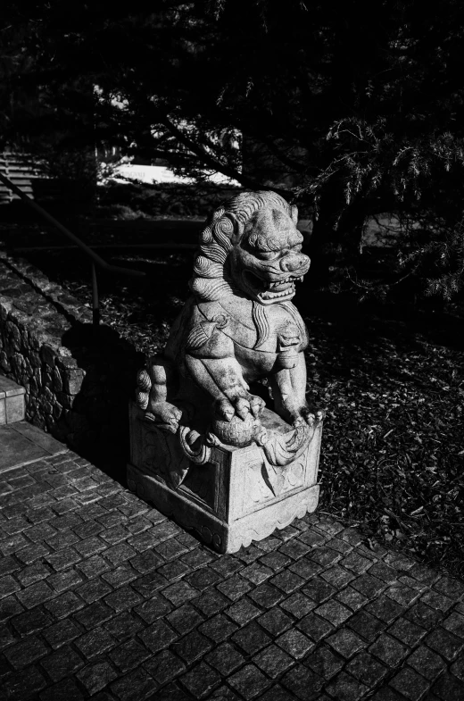 a black and white po of a statue of a small bear