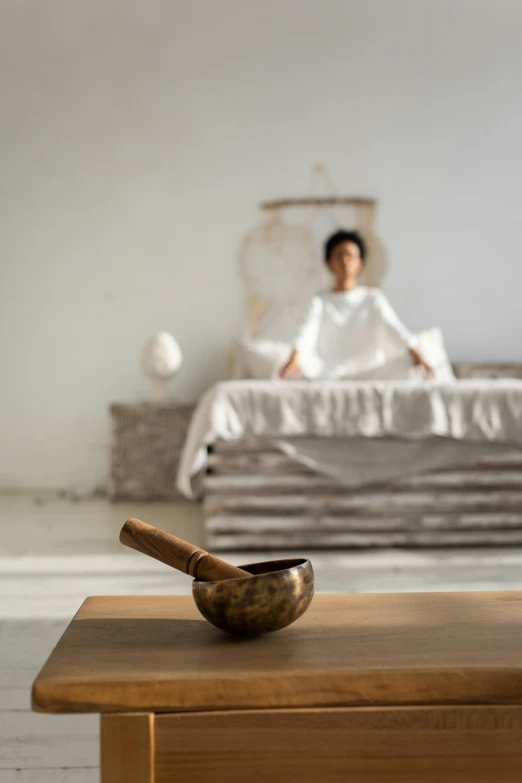 a man that is sitting on a bed with his feet propped up