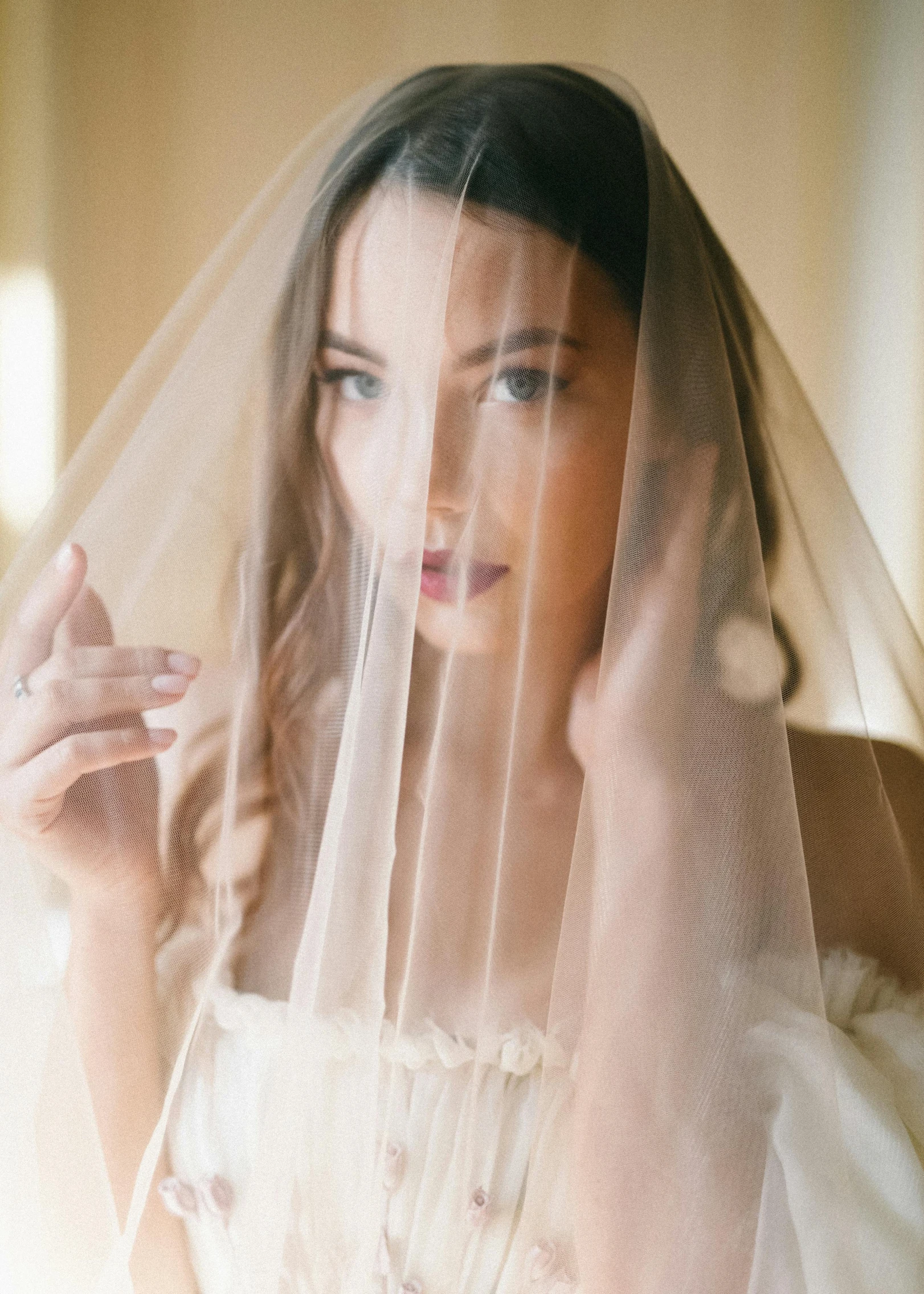 a woman is wearing a white wedding gown and veil