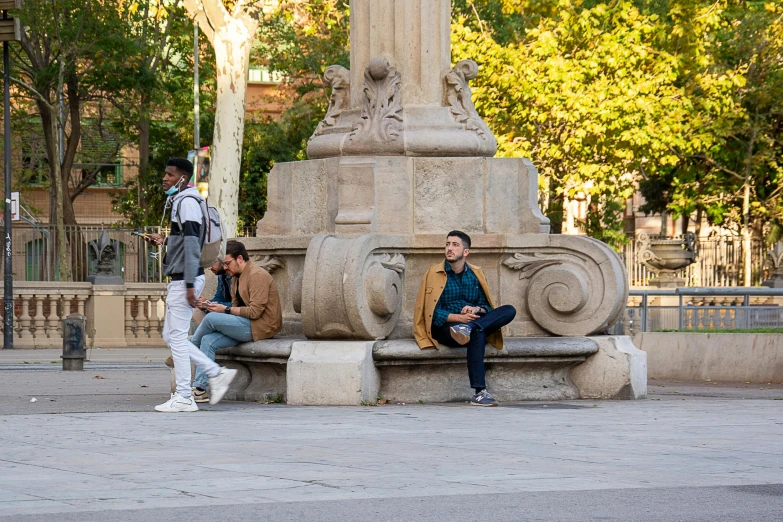 people sitting and relaxing on a bench in the park