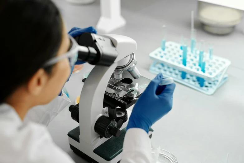 an image of a man using a microscope