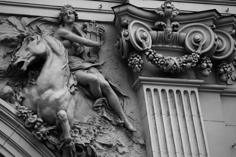 a building has decorative, horse carvings on the side of it