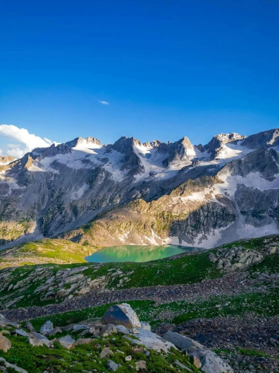 a large mountain covered in snow next to a lake