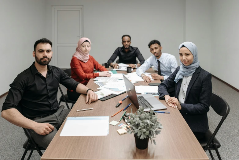 there are many people that are sitting at the table together