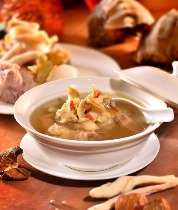 two white bowls filled with chicken and vegetable soup