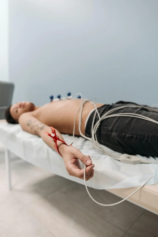 a man laying in bed with  dripping out of his hands