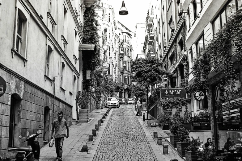 some buildings street cars and a person walking