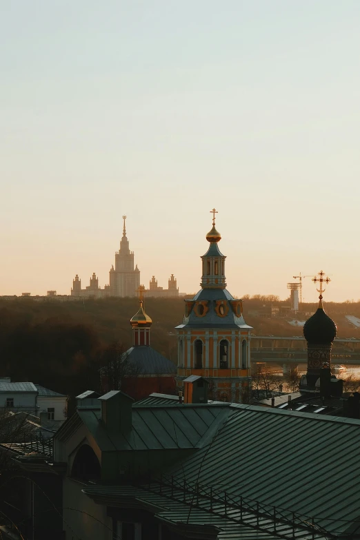 an orange and gold church steeple in the distance