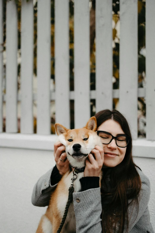 the woman is holding up her puppy for a po