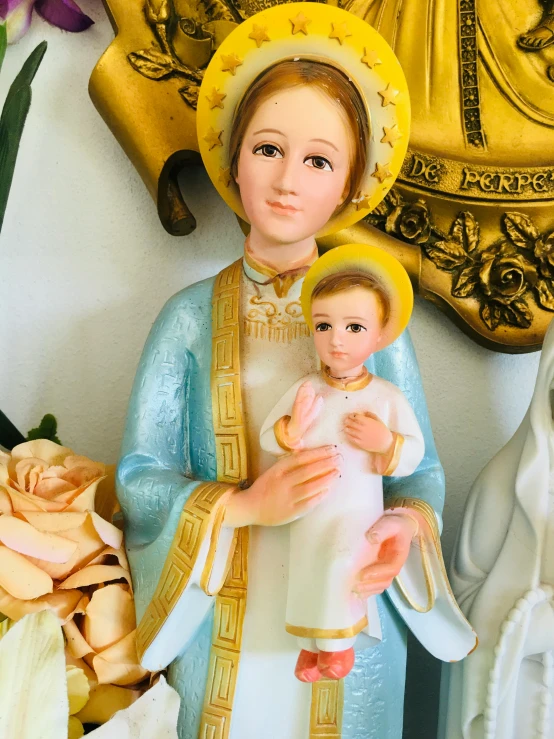 a statue of a baby jesus and a person wearing a robe