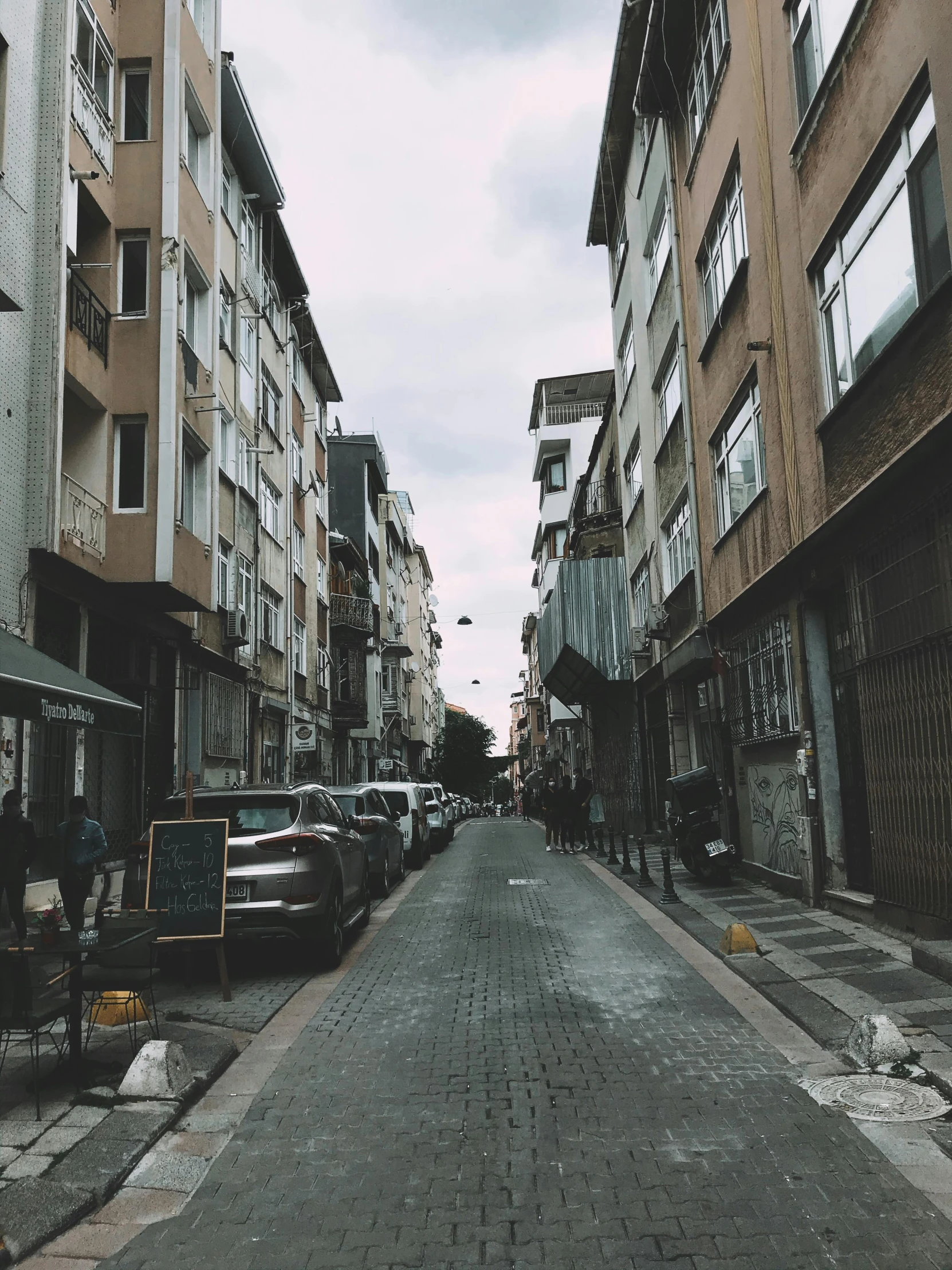 a very wide street with some cars and buildings