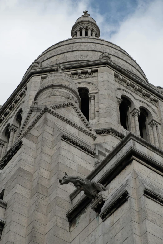 the old looking building features a statue of a gargoyle