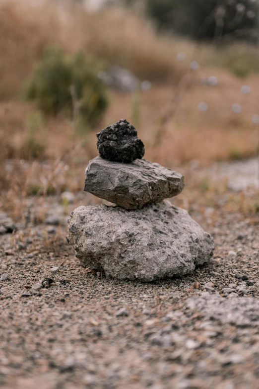 rock balanced on top of each other in front of grassy area