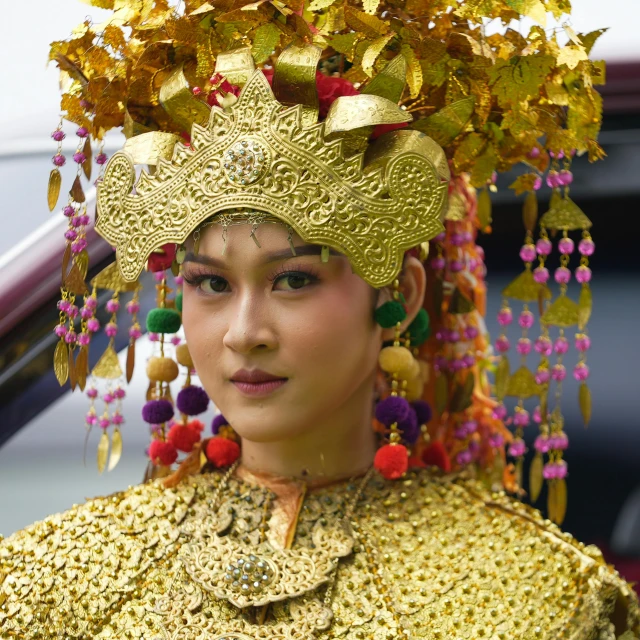 an asian girl in a golden costume