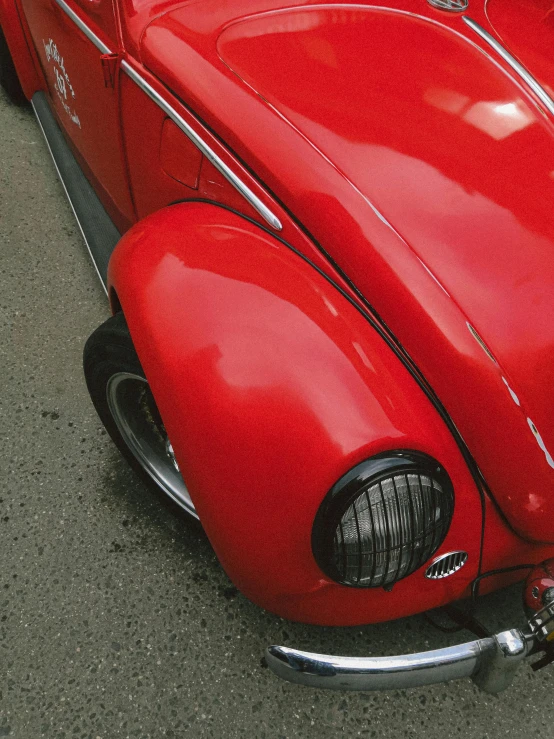 a close up of the front of an old red car