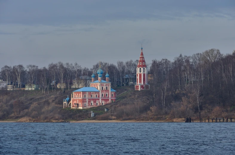 a church sits on top of a hill overlooking the ocean