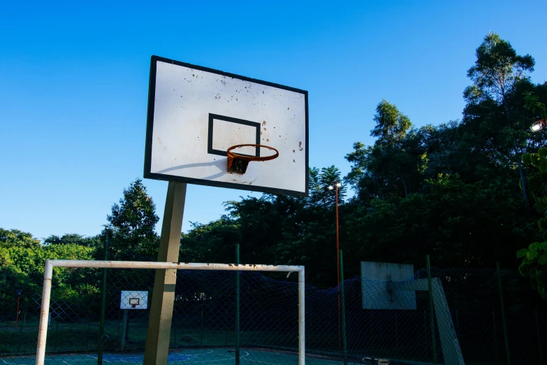 a basketball goal in front of some trees