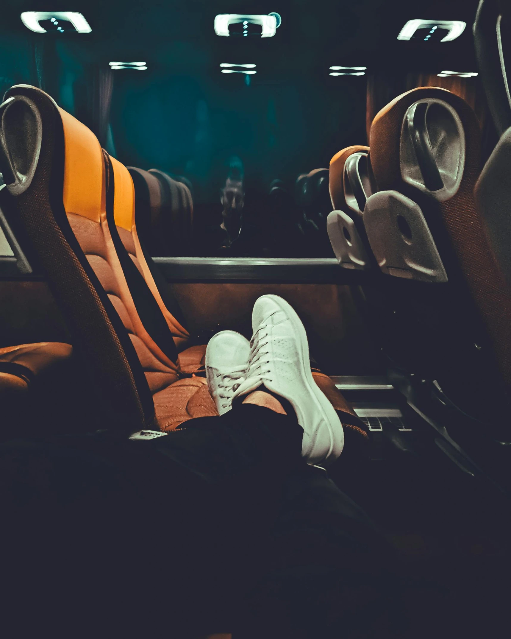 the pair of shoes are being used as seating for bus passengers