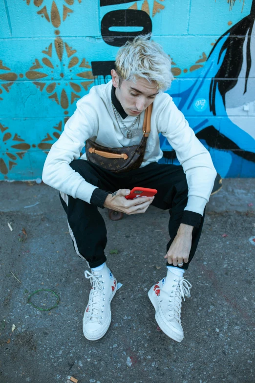 a man with blond hair is sitting down