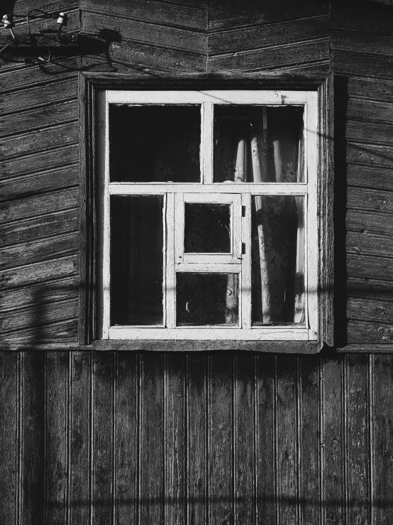 a po of a window and door inside a wooden cabin