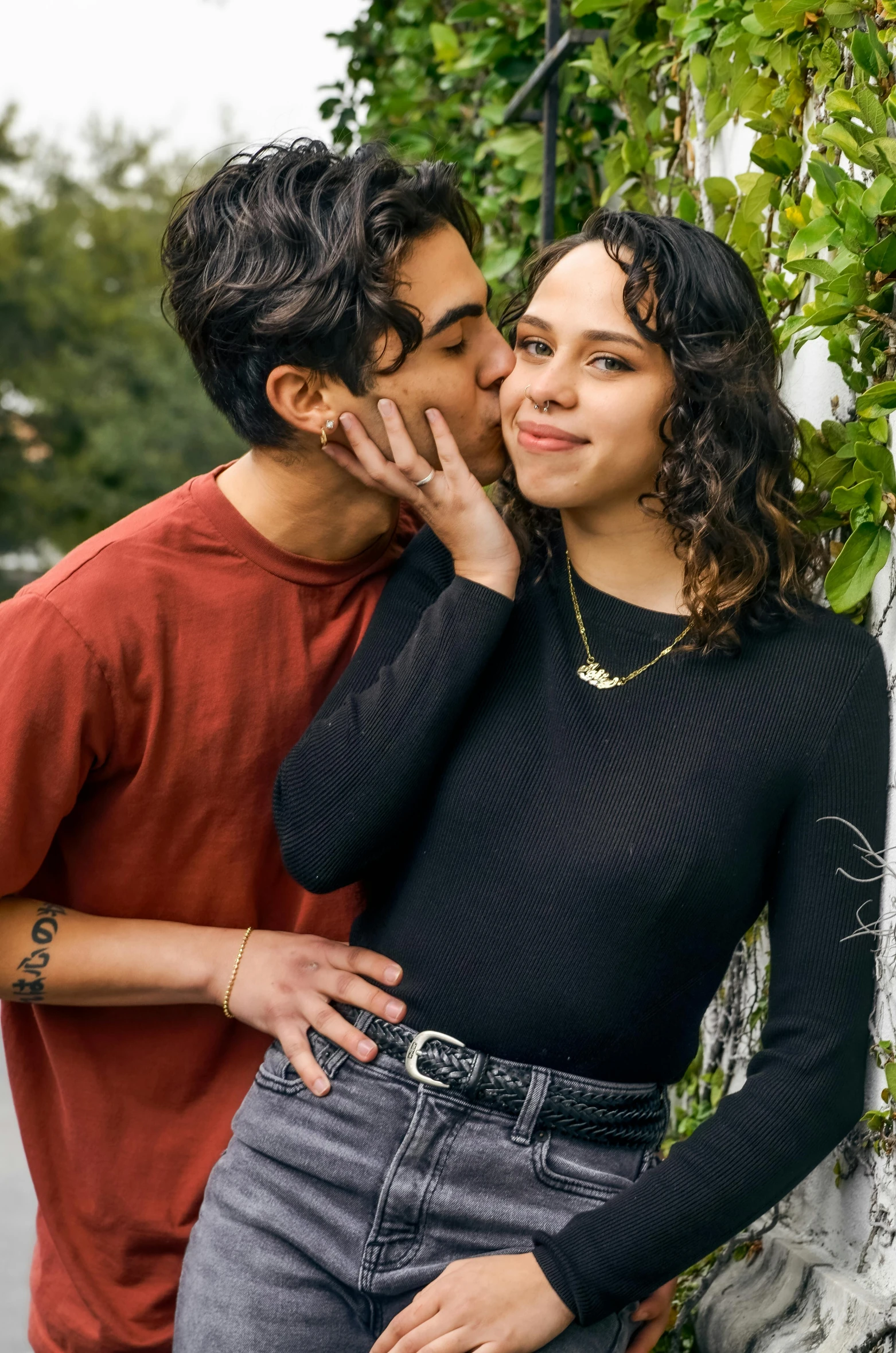 a young man and woman cuddling around each other