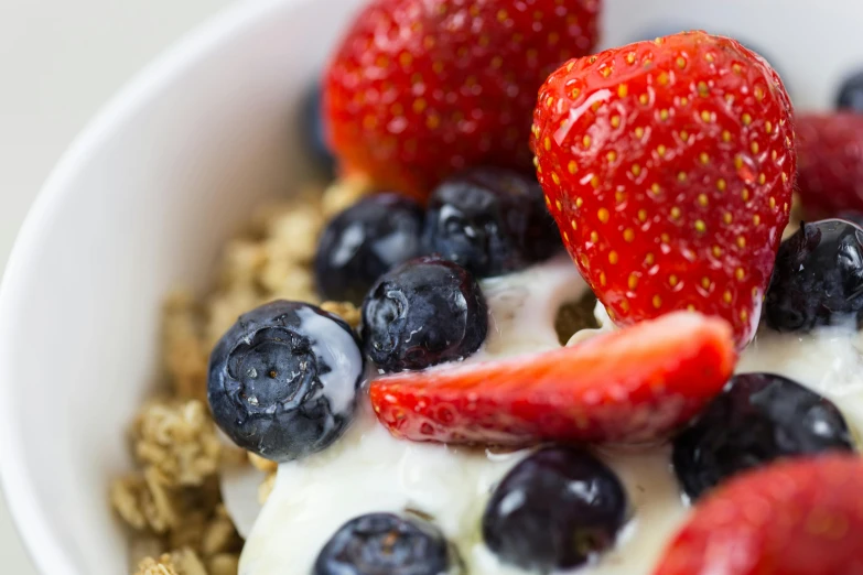 a bowl of fruit and granola is shown