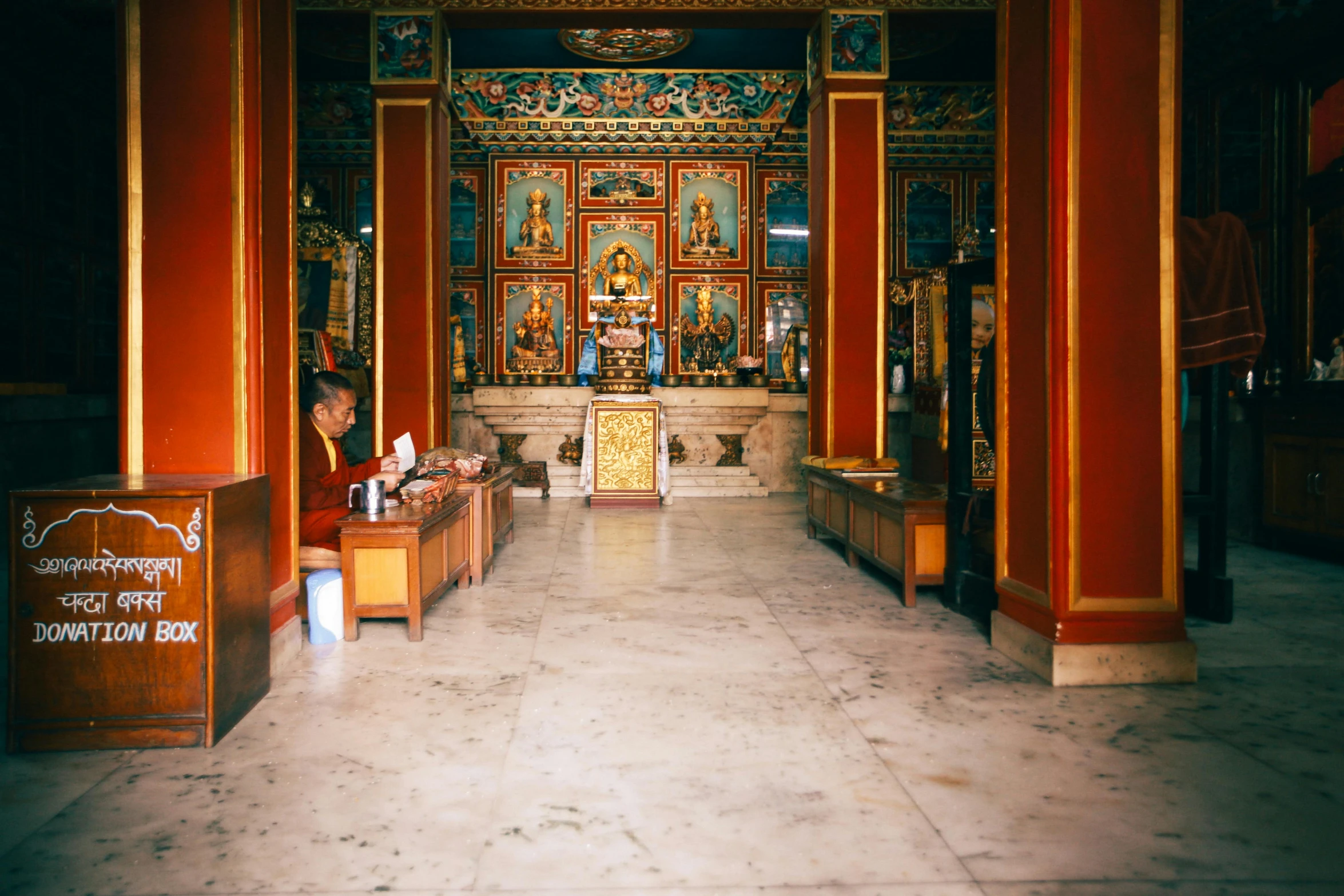 a woman sitting on a bench next to a statue