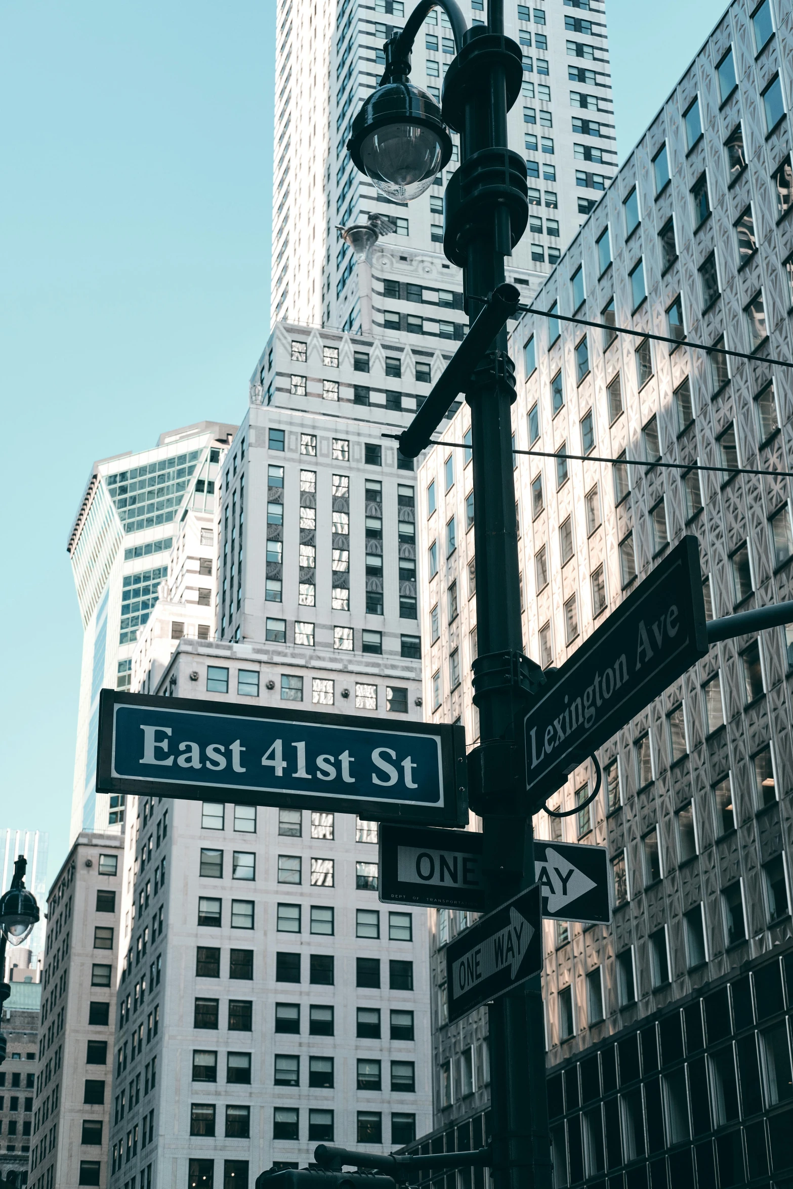 a city street sign showing east 1st and fifth