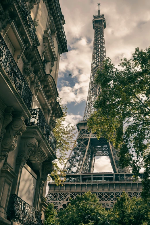 a tall tower towering over a city below trees