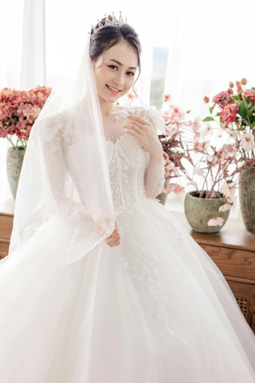a woman in a white wedding gown poses for a po