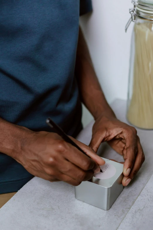 a man touching the side of a device on a counter