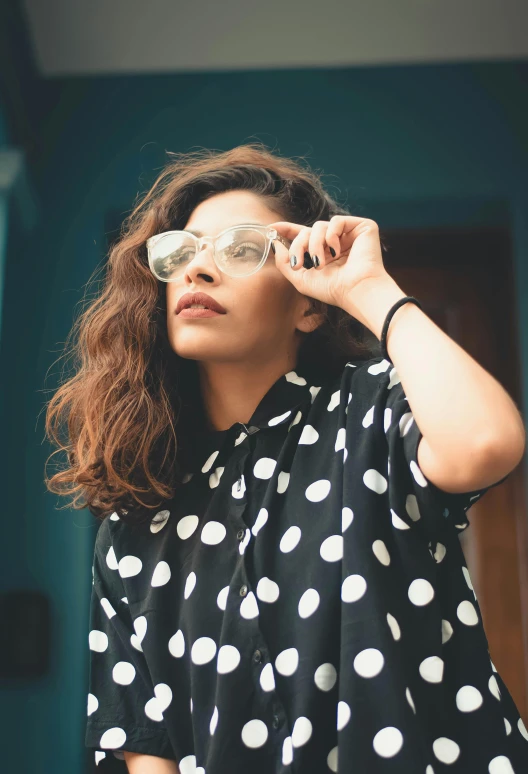 a woman wearing sunglasses and a shirt